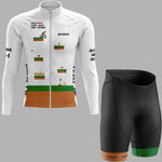 A cycling jersey and matching shorts shown on a plain gray background. The jersey is white with a retro video game pixel-art style print in green, orange, and black, including text on the chest and sleeves.